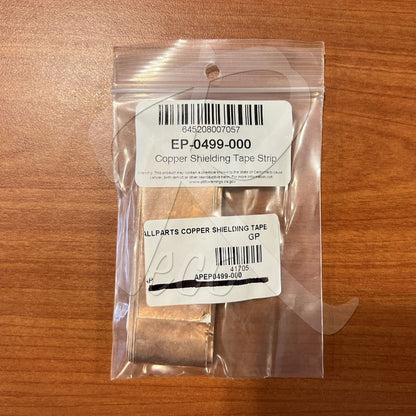 Copper shielding tape strip in clear packaging on a wooden surface