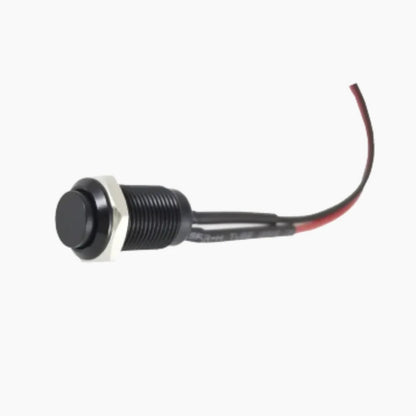 Black button switch with red wire on a white background