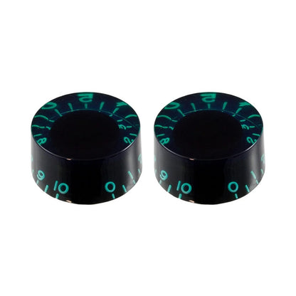 Two black knobs with green markings on a white background