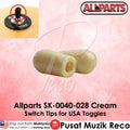 Two cream-colored plastic switch tips for USA toggles, shown on a pink background with an inset photo of a black toggle knob and text reading 'Allparts SK-0040-028 Cream Switch Tips for USA Toggles'.