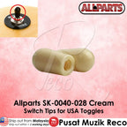 Two cream-colored plastic switch tips for USA toggles, shown on a pink background with an inset photo of a black toggle knob and text reading 'Allparts SK-0040-028 Cream Switch Tips for USA Toggles'.