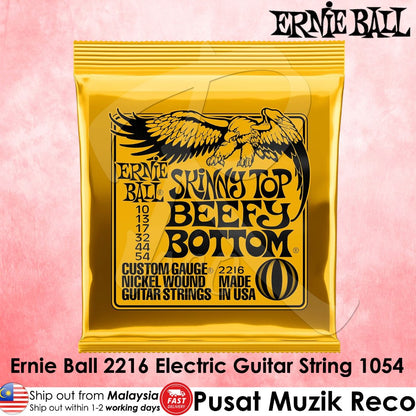 Ernie Ball Skinny Top Beefy Bottom electric guitar string package in a bright yellow pouch with black text and eagle graphic, shown on a pink background with product text overlays.