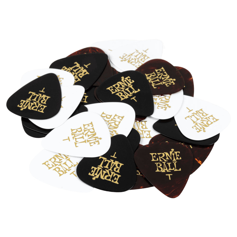 A pile of Ernie Ball guitar picks in black, white, and dark brown tortoiseshell finishes, each printed with the gold 'ERNIE BALL' logo, on a solid white background.