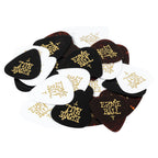 A pile of Ernie Ball guitar picks in black, white, and dark brown tortoiseshell finishes, each printed with the gold 'ERNIE BALL' logo, on a solid white background.