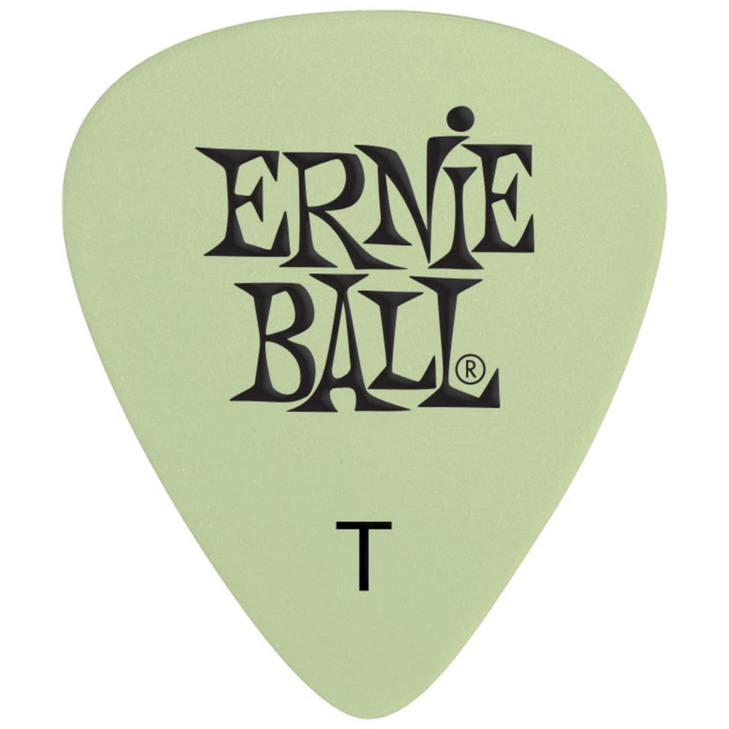 A single Ernie Ball guitar pick in a light sage green color with black printed branding and a 'T' shape indicator, shown on a solid white background.