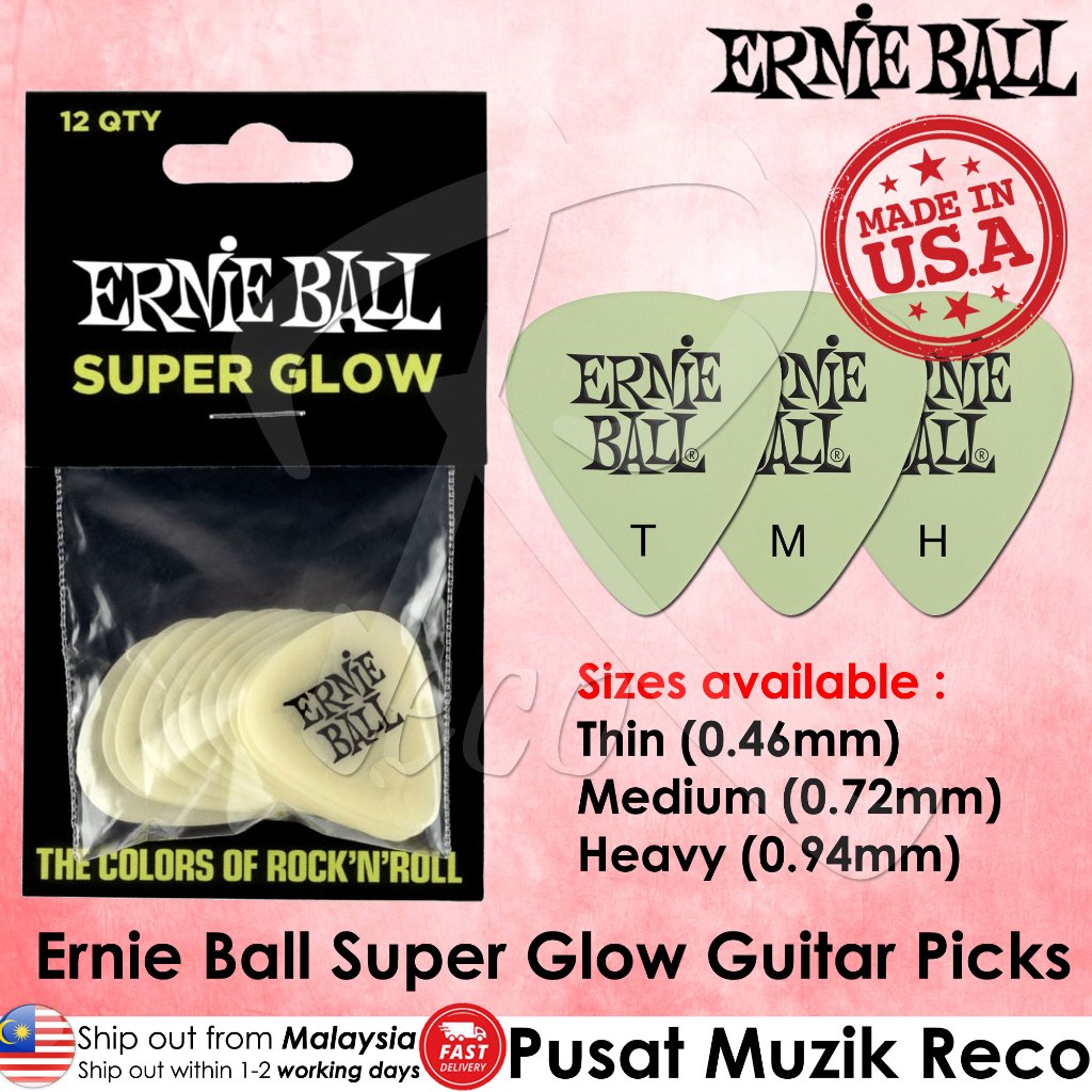 Ernie Ball Super Glow guitar picks in a black blister pack, shown alongside three pale green glow-effect picks labeled T, M, and H on a pink background. Text lists sizes 0.
