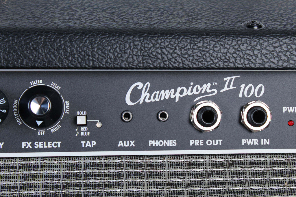 Close-up of a Champion II 100 guitar amplifier panel with control knobs and ports.