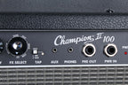 Close-up of a Champion II 100 guitar amplifier panel with control knobs and ports.