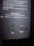 Back panel of electronic equipment with USB port, recovery, and firmware update ports, and warning labels.