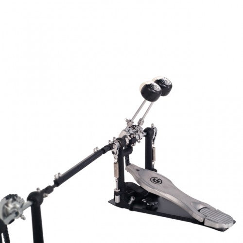 A double bass drum pedal with a black footplate, silver metal striker arms, and black drumheads, shown on a white background.
