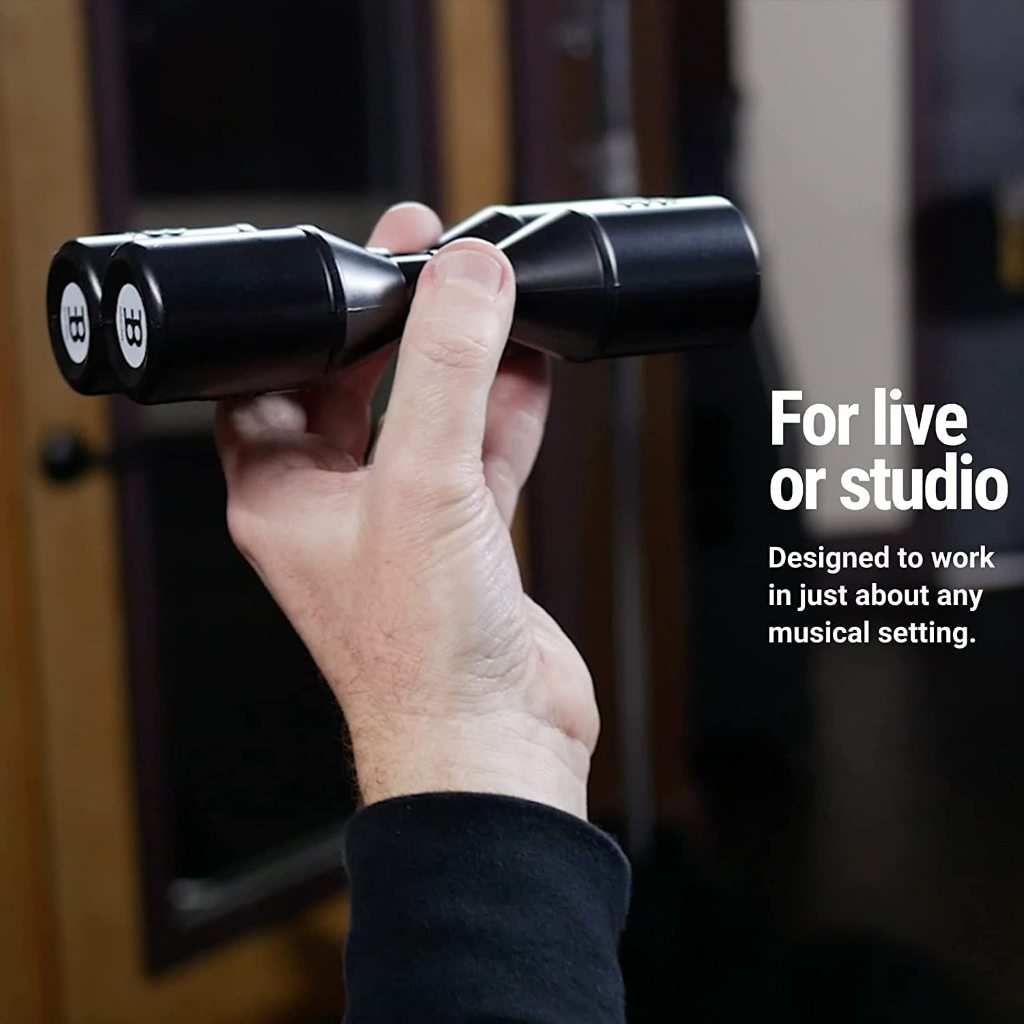 A hand holding a black dual-microphone wireless recorder, with text on the right reading 'For live or studio' and 'Designed to work in just about any musical setting.'.