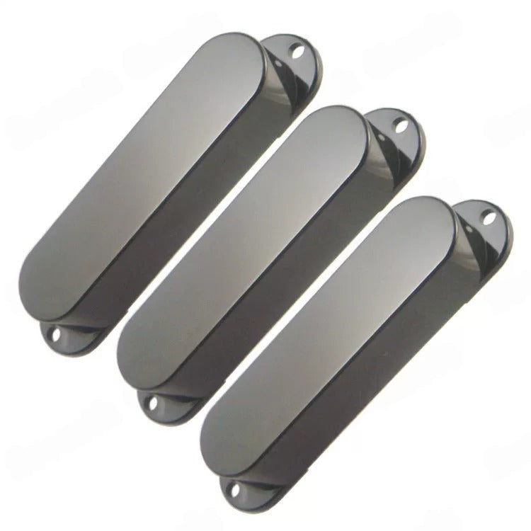 Three dark gray glossy oval-shaped guitar pickups or control covers arranged diagonally on a plain white background.