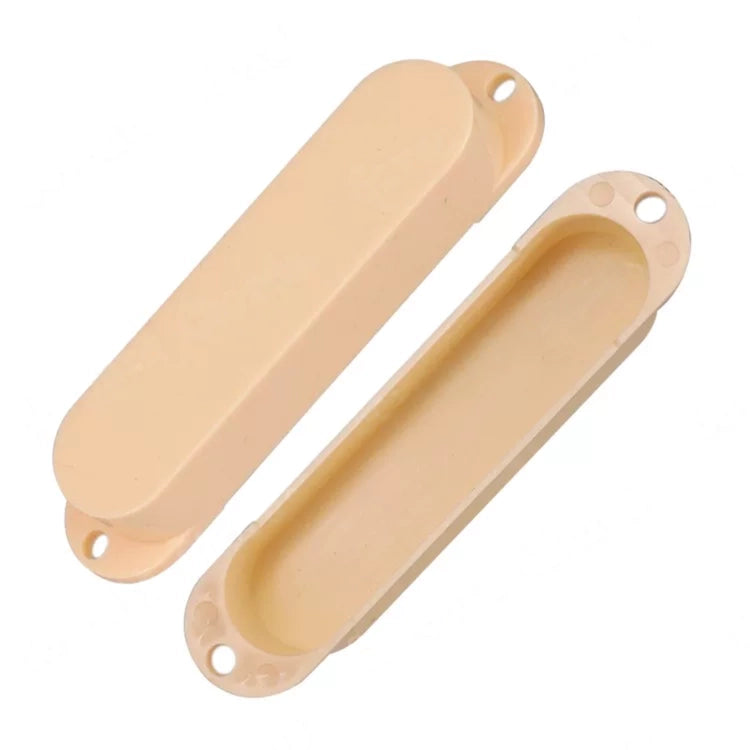 Two beige plastic guitar volume knobs, one showing the top cover and the other showing the recessed interior, on a white background.
