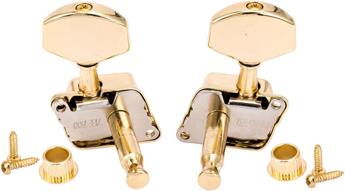 Pair of gold guitar tuners with screws and washers on a white background