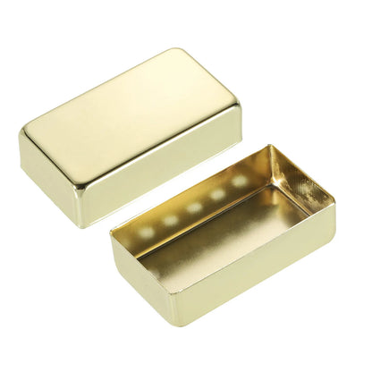 A pair of rectangular gold-toned metal boxes, one closed and one open, shown on a plain white background.