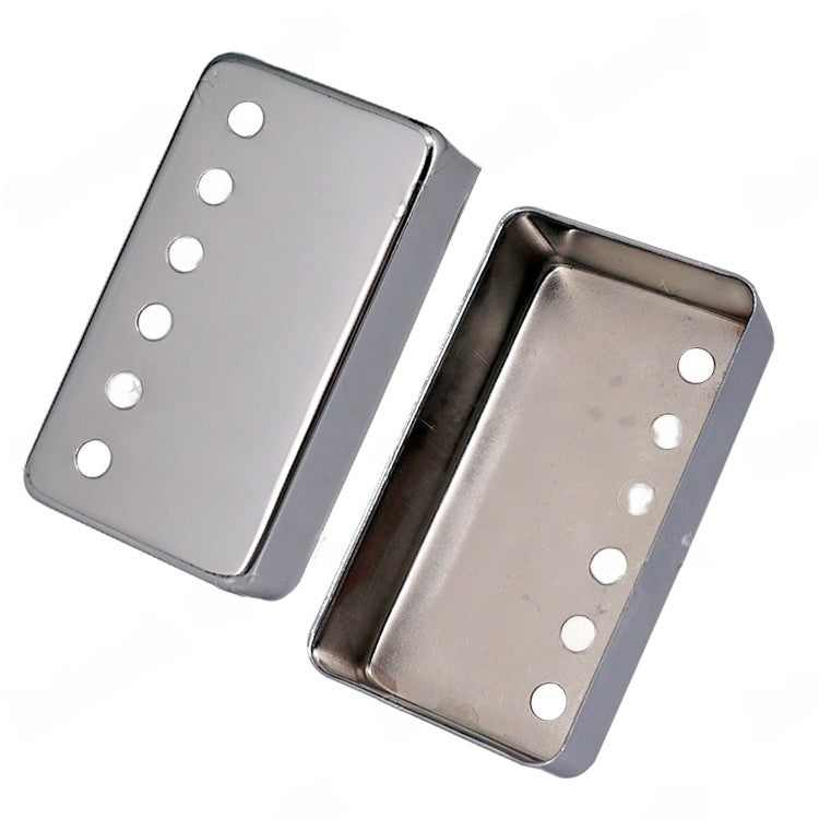 Two metallic silver guitar bridge pickups shown on a plain white background, one displaying the top side with mounting holes and the other showing the inner cavity.