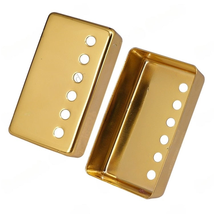 Two gold metal guitar pickups shown on a plain white background, one displaying the front face with six screw holes and the other showing the side profile.