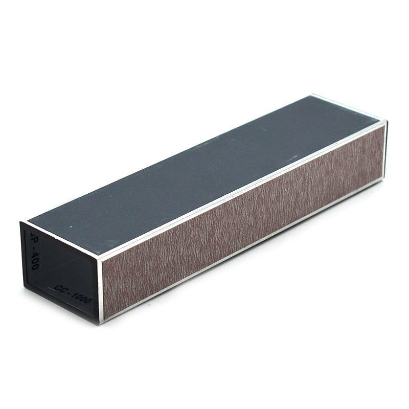 A rectangular sharpening stone or honing block with a dark gray top surface, brown abrasive side, and black end cap, shown on a plain white background.