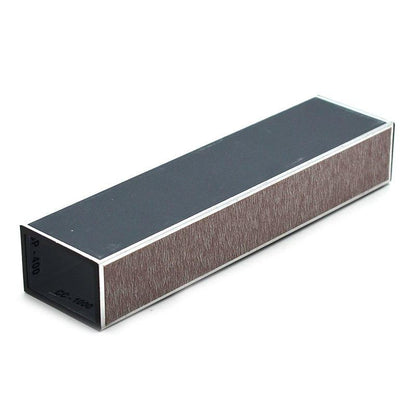 A rectangular sharpening stone or honing block with a dark gray top surface, brown abrasive side, and black end cap, shown on a plain white background.