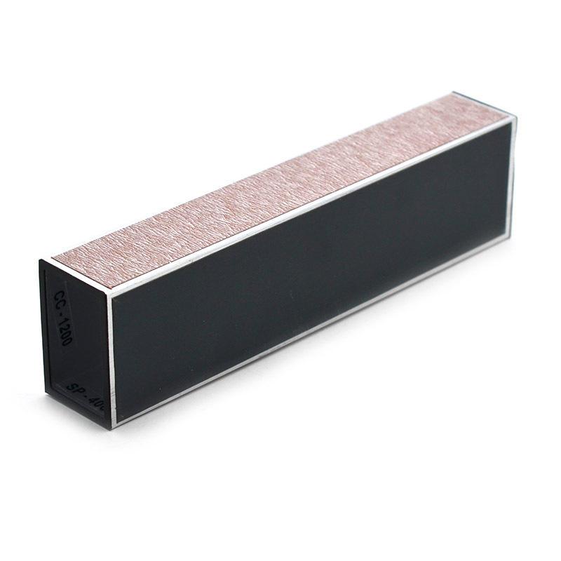 A rectangular metal nail file with a black body, silver edges, and a pinkish-beige abrasive top surface, shown on a plain white background.