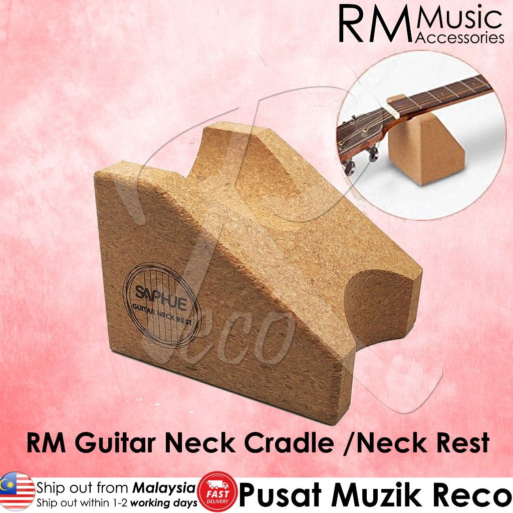 A cork guitar neck cradle shown on a pink background, with a small inset showing part of a guitar neck resting on it. Text includes RM Music Accessories branding and Malay text describing the product.