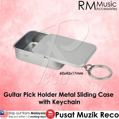 A silver metal guitar pick holder keychain case with a sliding lid and attached keyring, shown on a pink background with text overlays from RM Music Accessories and Pusat Muzik Reco.