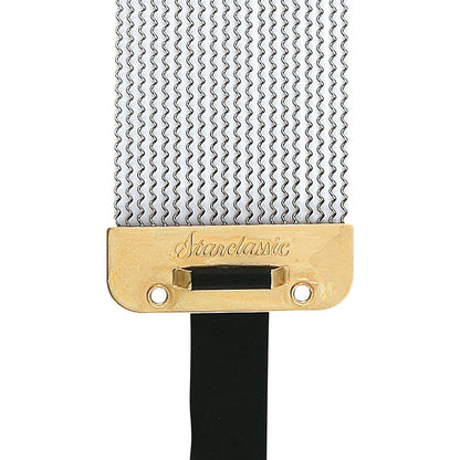 Close-up of a Stanelastic guitar string bridge with a gold-plated metal plate engraved with the brand name, a black saddle bar, and silver metal string trees on a white background.