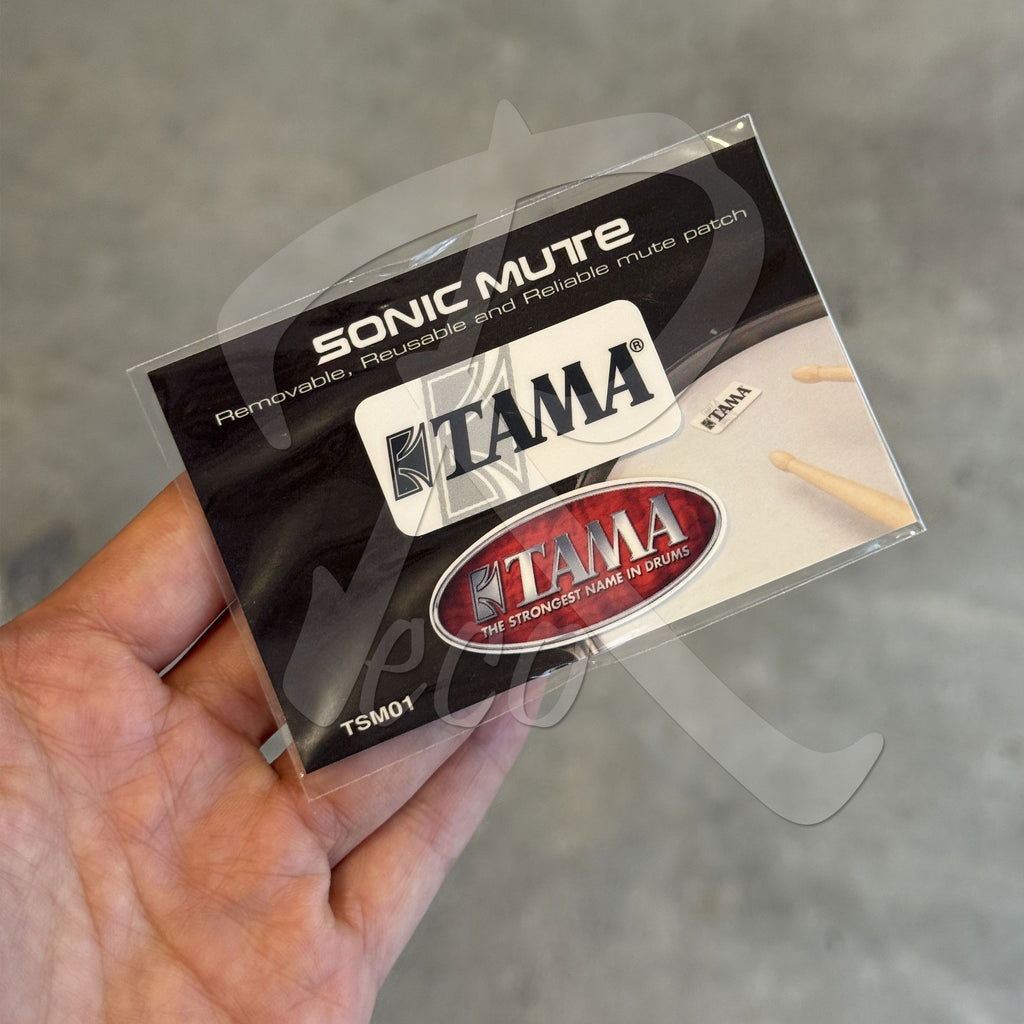 TAMA Sonic Mute packaging held in a hand with a gray background
