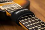 Gruv Gear FretWrap macro close-up showing fabric texture and Velcro strap on guitar neck